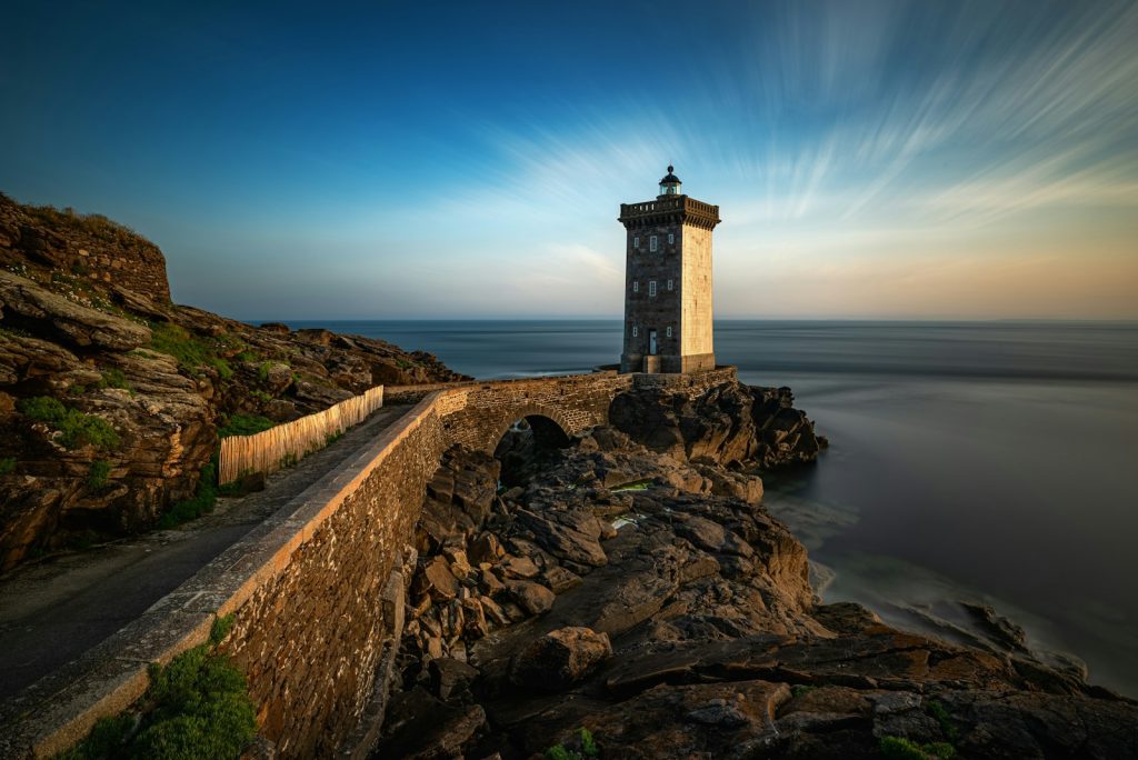 Lighthouse stands tall on a rocky coastline.
